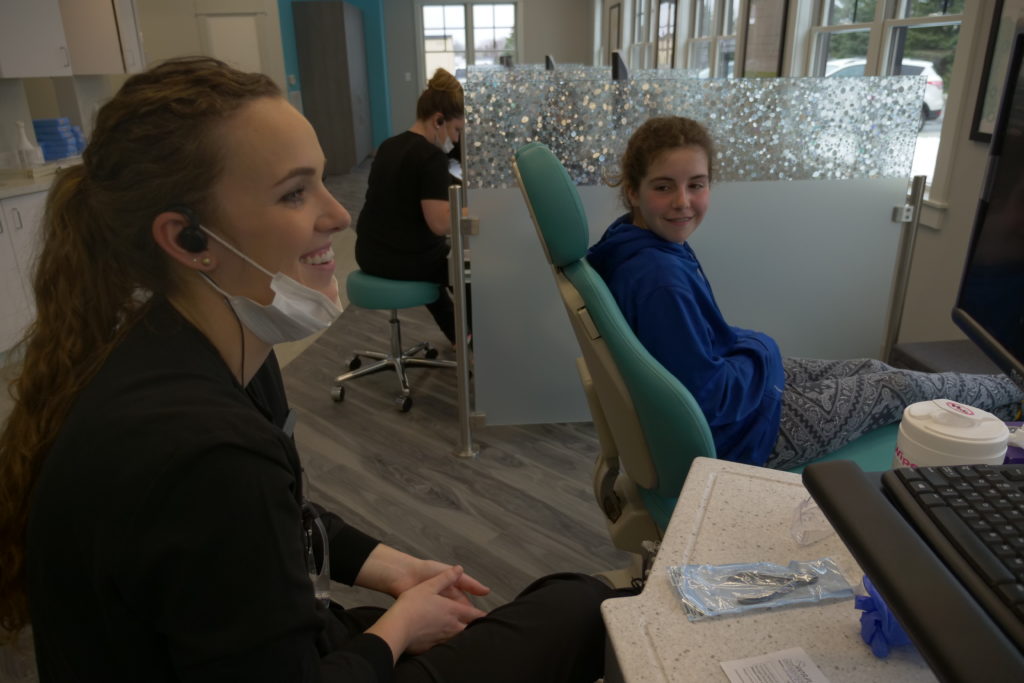 Swan Orthodontics staff working with a patient