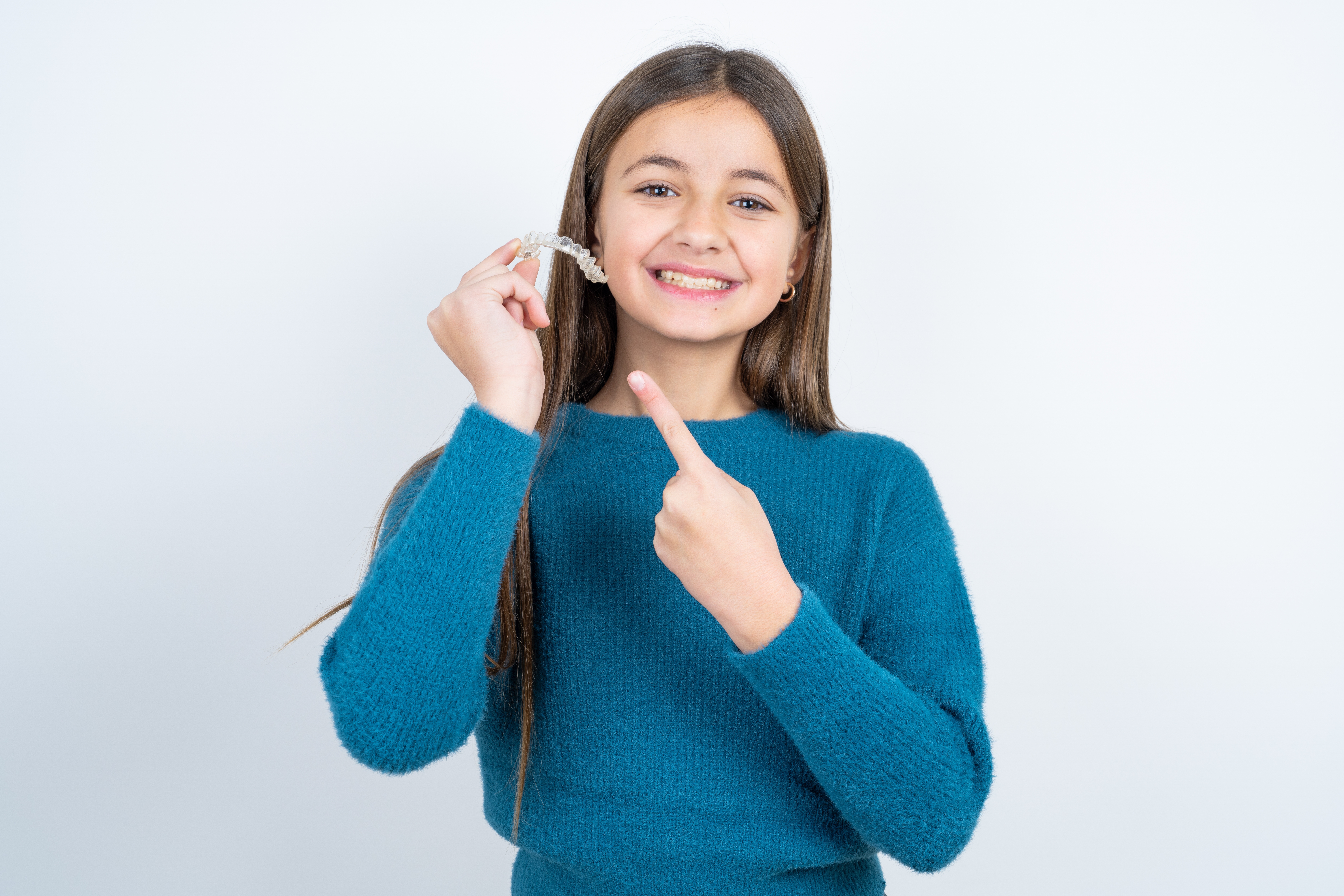 Beautiful,Kid,Girl,Wearing,Blue,T-shirt,Over,White,Background,Holding Beautiful,Kid,Girl,Wearing,Blue,T-shirt,Over,White,Background,Holding